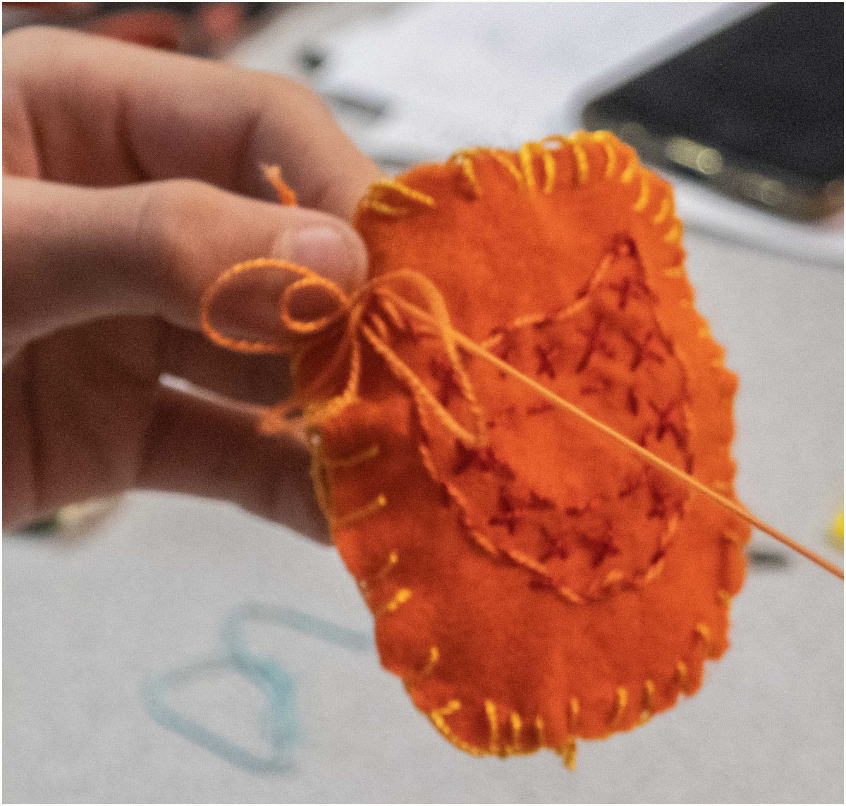 Edging a badge with blanket stitch